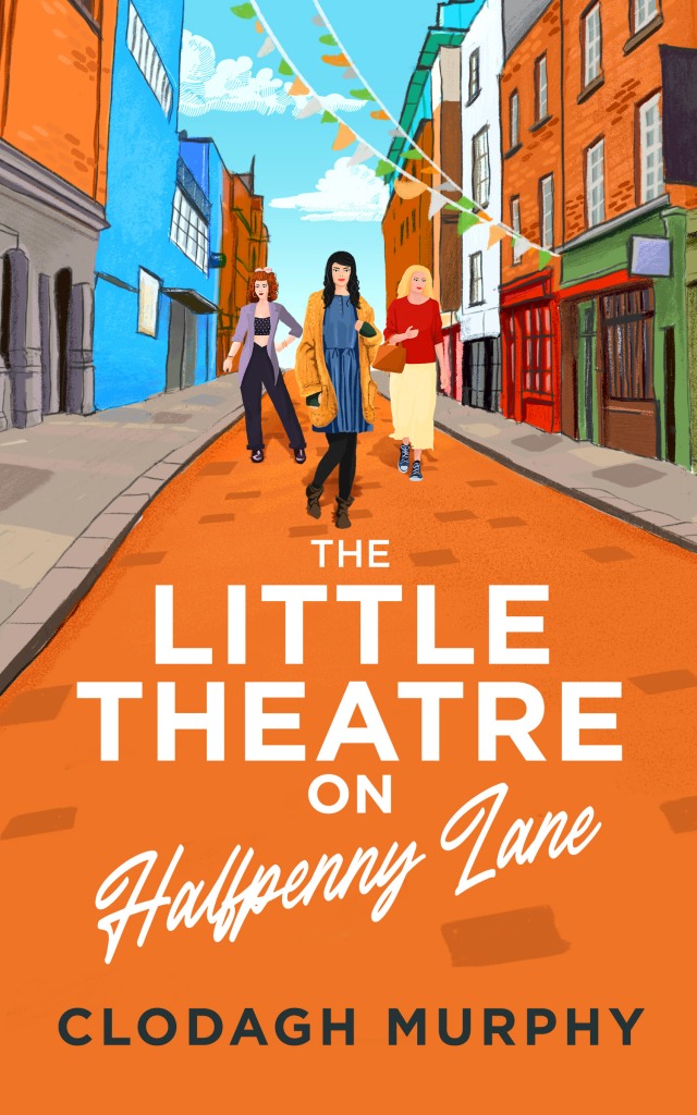 Book cover of The Little Theatre of Halfpenny Lane by Clodagh Murphy.
Predominantly orange cover, 3 women walk on the road on an old fashioned street with bunting looped across shops. 